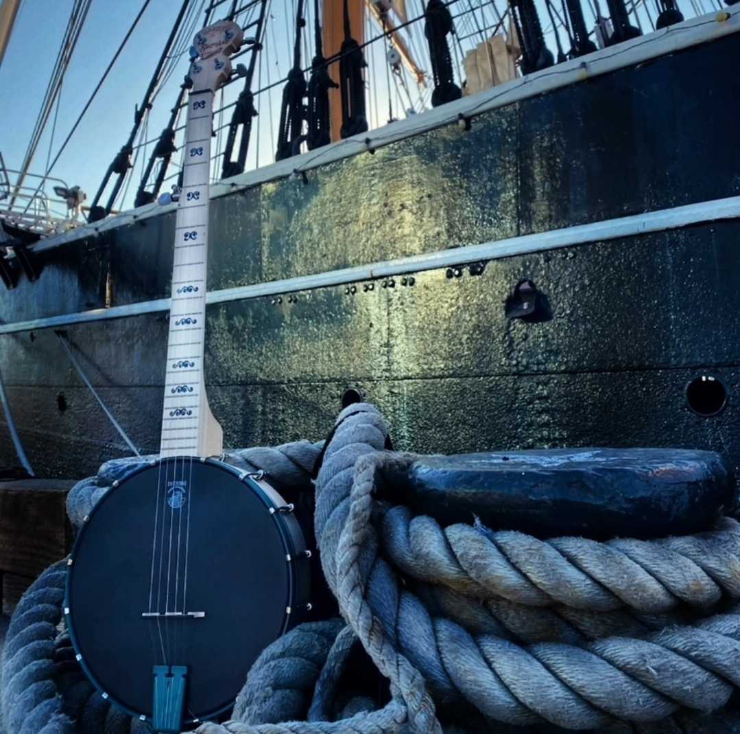 Swept Away Broadway Play Goodtime Banjo Full Banjo Shot with Sailing ship behind it